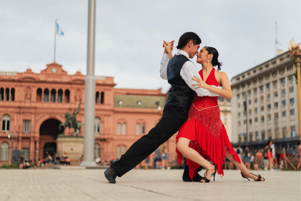 travel to argentina man and woman dancing in a city square