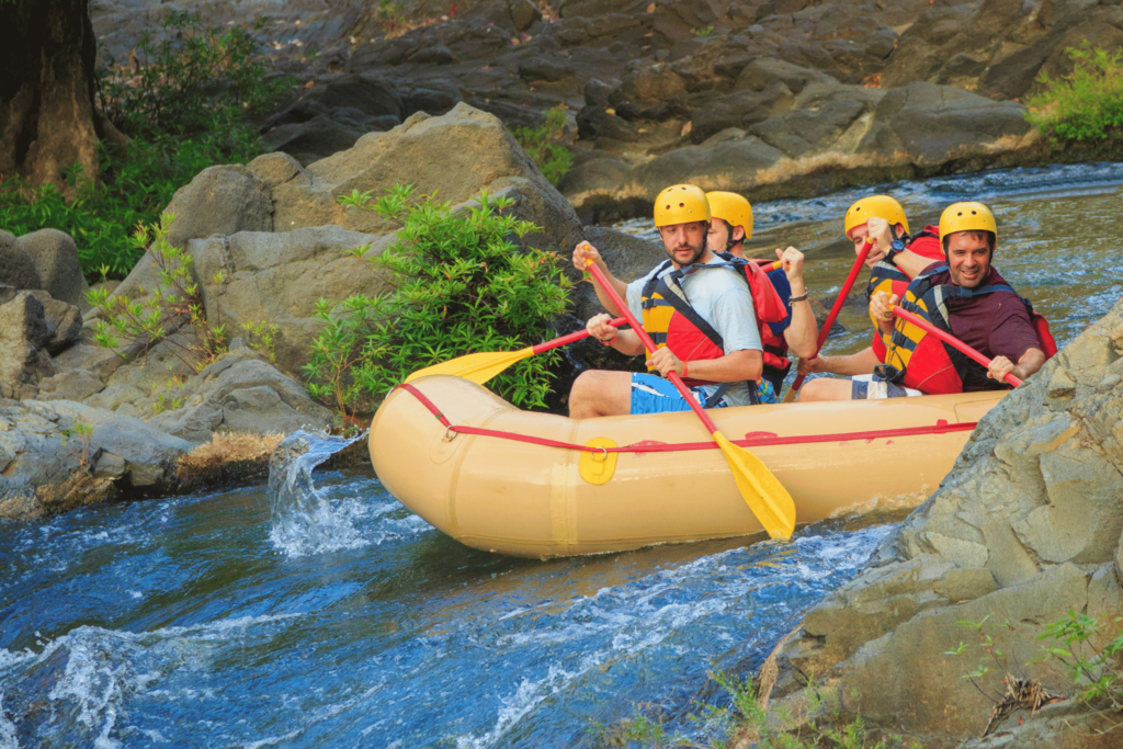 family in raft heading down a river